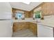 Classic kitchen featuring light countertops, wood cabinets, and standard appliances at 797 Michigan Ave, Englewood, FL 34223