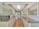 Eat-in kitchen with long counters, tile backsplash and stainless steel microwave at 797 Michigan Ave, Englewood, FL 34223