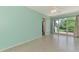 Bright living room with terrazzo flooring, ceiling fan, and sliding glass doors at 797 Michigan Ave, Englewood, FL 34223