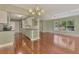 The living room and kitchen offer an open concept with lots of natural light and wood floors at 797 Michigan Ave, Englewood, FL 34223