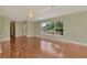 Spacious living room with lots of natural light, wood flooring and views of the front yard at 797 Michigan Ave, Englewood, FL 34223