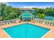 Inviting community pool with plenty of lounge chairs at 19365 Water Oak Dr # 203, Port Charlotte, FL 33948