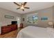 Bedroom with wood dresser, ceiling fan, and access to backyard at 3359 Osprey Ln, Port Charlotte, FL 33953