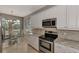 Spacious kitchen with stainless steel appliances and granite countertops at 3359 Osprey Ln, Port Charlotte, FL 33953