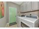Laundry room with washer, dryer, and built-in cabinets at 3359 Osprey Ln, Port Charlotte, FL 33953
