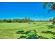 Expansive green golf course with golf carts in view at 3359 Osprey Ln, Port Charlotte, FL 33953