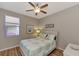 Cozy bedroom with coral bedding and a ceiling fan at 3359 Osprey Ln, Port Charlotte, FL 33953