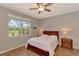 Spacious bedroom with a wood bed frame, ceiling fan, and large window at 3359 Osprey Ln, Port Charlotte, FL 33953