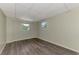 Simple bedroom with two windows and wood-look floors at 797 Michigan Ave, Englewood, FL 34223