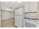 White appliances and light flooring in this kitchen at 797 Michigan Ave, Englewood, FL 34223