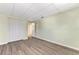Empty bedroom with wood-look floors and an open door at 797 Michigan Ave, Englewood, FL 34223