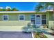 Light green house exterior with a screened front door at 797 Michigan Ave, Englewood, FL 34223