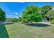 Large grassy backyard with mature mango trees at 797 Michigan Ave, Englewood, FL 34223