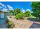 Landscaped backyard with mature trees and flagstone path at 797 Michigan Ave, Englewood, FL 34223