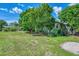 House with lush green yard and mature trees at 797 Michigan Ave, Englewood, FL 34223