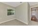 Bedroom with carpet, single window, and view of hallway at 797 Michigan Ave, Englewood, FL 34223