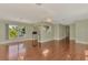 Bright living room with hardwood floors and a view into the kitchen at 797 Michigan Ave, Englewood, FL 34223