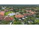 Aerial view of community with lake and condo buildings at 504 Pine Hollow Cir # 504, Englewood, FL 34223