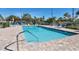 Inviting community pool with lounge chairs and shaded seating area at 504 Pine Hollow Cir # 504, Englewood, FL 34223