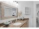 Well-lit bathroom with granite countertop and a large mirror at 504 Pine Hollow Cir # 504, Englewood, FL 34223