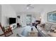 Living room with vaulted ceiling, comfy seating, and access to balcony at 504 Pine Hollow Cir # 504, Englewood, FL 34223