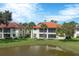 Back view of condo building and pond at 504 Pine Hollow Cir # 504, Englewood, FL 34223