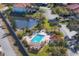 Aerial view showing community pool, landscaping, and pond at 504 Pine Hollow Cir # 504, Englewood, FL 34223