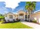 Beautiful two-story house with manicured landscaping and walkway at 247 Tournament Rd, Rotonda West, FL 33947