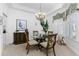 Bright dining room with glass table and four chairs, hardwood floors and window seating at 247 Tournament Rd, Rotonda West, FL 33947