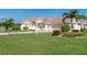 One-story house with palm trees, manicured lawn, and driveway at 8216 Parkside Dr, Englewood, FL 34224