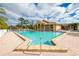 Community pool with lounge chairs and spa at 8216 Parkside Dr, Englewood, FL 34224