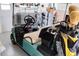 Golf cart parked in garage with golf clubs at 8216 Parkside Dr, Englewood, FL 34224