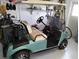 Teal golf cart with storage and accessories at 8216 Parkside Dr, Englewood, FL 34224