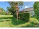 Private backyard with lush landscaping and a hedge for added seclusion at 8216 Parkside Dr, Englewood, FL 34224