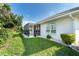 Landscaped backyard with a screened patio, offering privacy and outdoor enjoyment at 8216 Parkside Dr, Englewood, FL 34224