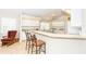 Kitchen features a breakfast bar with seating, granite counters, and white cabinets at 8216 Parkside Dr, Englewood, FL 34224