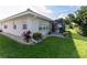 Neatly landscaped backyard showcasing the home's exterior and screened patio at 8216 Parkside Dr, Englewood, FL 34224