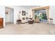 Living room with cream sofa, coffee table, and sliding doors to a lanai at 8216 Parkside Dr, Englewood, FL 34224