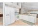 White kitchen features granite counters, stainless steel appliances, and ample cabinet space at 8216 Parkside Dr, Englewood, FL 34224