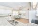Kitchen with granite countertops, white cabinets, and a breakfast nook at 8216 Parkside Dr, Englewood, FL 34224