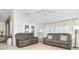 Relaxing living room with two reclining sofas and tiled floors at 8216 Parkside Dr, Englewood, FL 34224