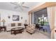 Spacious living area with light colored sofa, access to screened patio at 8216 Parkside Dr, Englewood, FL 34224