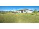 Large backyard with grassy area and view of neighboring homes at 2232 Bonito Way, Port Charlotte, FL 33953