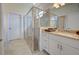 Bathroom with granite countertop, white cabinets, and a glass shower at 2232 Bonito Way, Port Charlotte, FL 33953