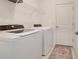 White washer and dryer in well-lit laundry room at 2232 Bonito Way, Port Charlotte, FL 33953