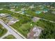 Aerial view showing property, neighborhood, and nearby road at 13401 Galveston Ave, Port Charlotte, FL 33981