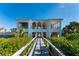 White two-story clubhouse with arched entryway and walkway at 11100 Hacienda Del Mar Blvd # 202, Placida, FL 33946