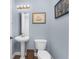 Small bathroom with pedestal sink, toilet and nautical decor at 11100 Hacienda Del Mar Blvd # 202, Placida, FL 33946