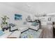 Open living room featuring white sectional sofa, a large area rug, and a view into the kitchen at 11100 Hacienda Del Mar Blvd # 202, Placida, FL 33946