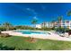 Community pool with surrounding patio and lounge chairs at 11100 Hacienda Del Mar Blvd # 202, Placida, FL 33946